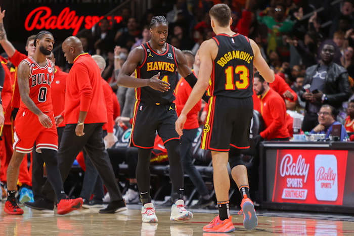 Hawks forward AJ Griffin and Hawks guard Bogdan Bogdanovic react after a play.